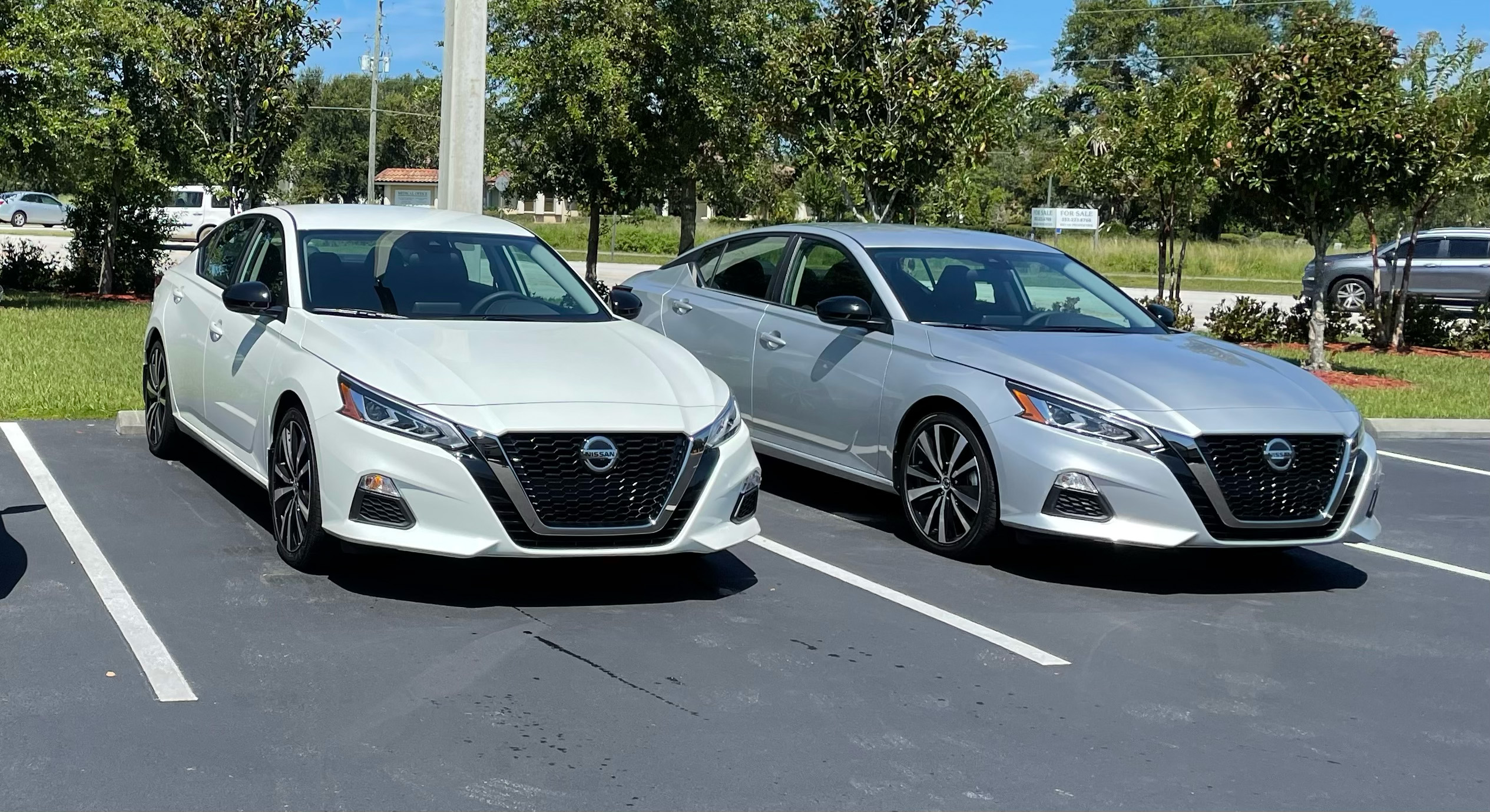 Photo of Tax Collector's Office Driving Test Vehicles, two Nissan Altimas parking next to each other. 